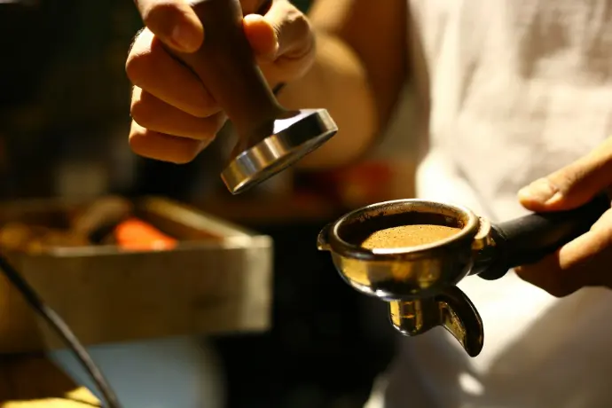 person holding silver steel cup